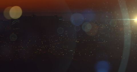 Vibrant Urban Skyline at Dusk with Illuminated City Lights