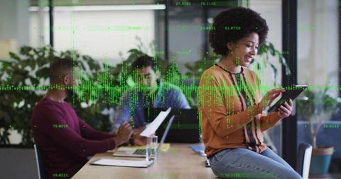 Businesswoman Analyzing Digital Data with Team in Office Environment