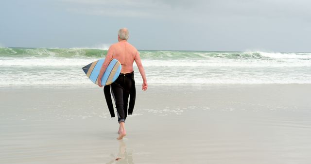 Senior Man Ready to Surf on Beach - Download Free Stock Images Pikwizard.com