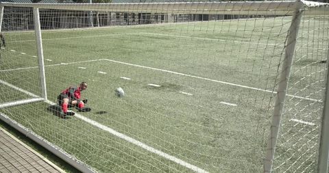 Young soccer player focusing on goal scoring training