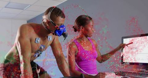 Athlete performing vo2 max test while technician reviewing real-time performance data