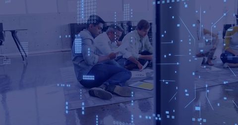 Team Analyzing Documents with Digital Overlay in Modern Office