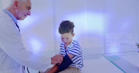 Pediatric checkup with doctor examining child's blood pressure