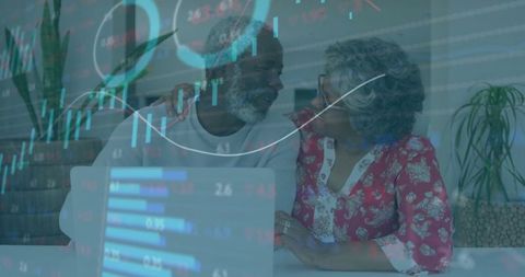 Senior Couple Analyzing Investment Data on Laptop at Home