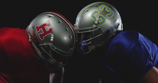 Two Football Players in Helmets Facing Each Other in Intense Competition - Download Free Stock Images Pikwizard.com