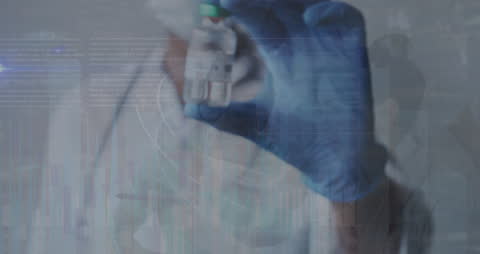 Doctor Analyzing Data with Vaccine Vial