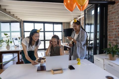 Colleagues Celebrating Birthday in Modern Office with Cupcakes and Balloons