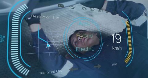 Female automotive technician inspecting hybrid vehicle underbody with futuristic hud