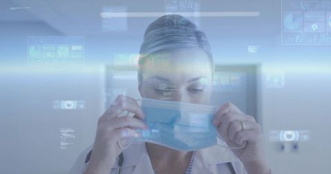Female doctor placing surgical mask with holographic medical interface for telemedicine