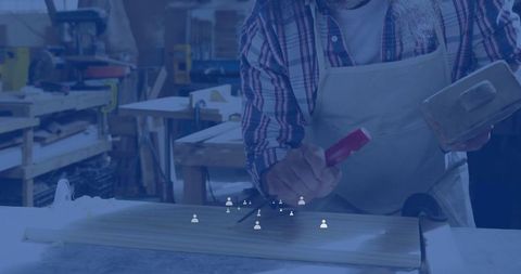 Skilled carpenter marking wood for crafting