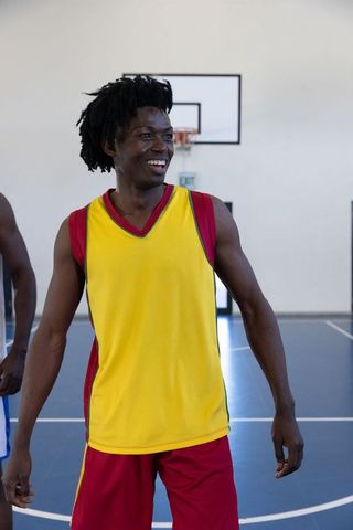 African American Basketball Players Team Joy in Vibrant Jerseys on Court