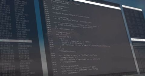 Dual monitors displaying javascript code in modern workspace