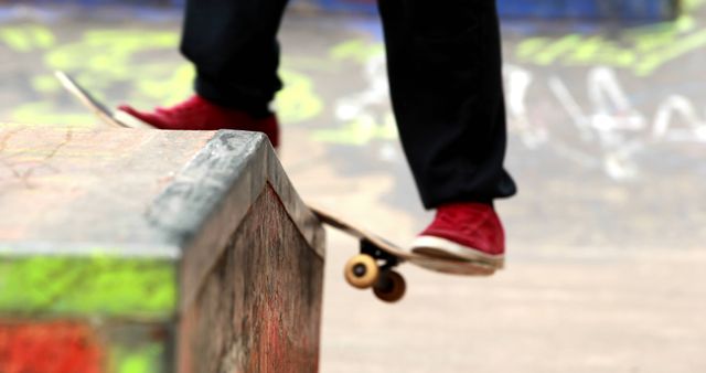 Young skateboarder skating the outdoor skatepark on a bright day