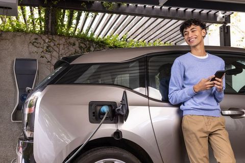 Young Man Enjoying Eco-Friendly Transportation with Electric Vehicle