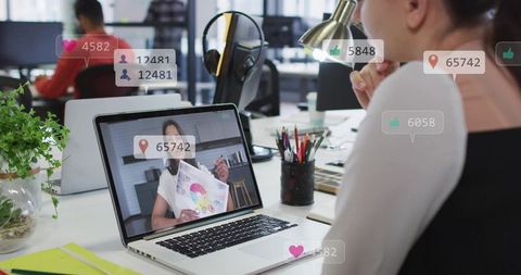 Remote design presentation in modern open office with social media engagement overlays