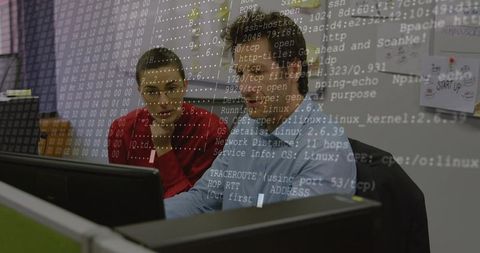 IT colleagues collaborating on code review with terminal overlay on dual monitors