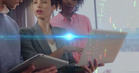 Diverse Business Team Collaborating with Laptop and Tablet