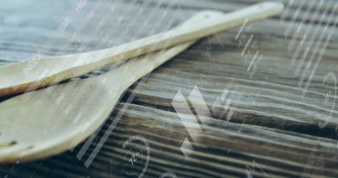 Wooden spatulas on rustic countertop with data overlays