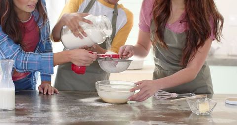 Diverse Friends Collaborating in Kitchen for Homemade Baking Fun