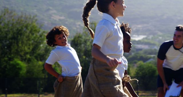 Happy Group of Children in Sack Race Outdoors - Download Free Stock Images Pikwizard.com