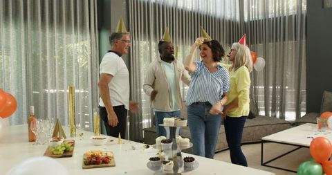 Joyful office party with multiracial team, confetti flying celebrations