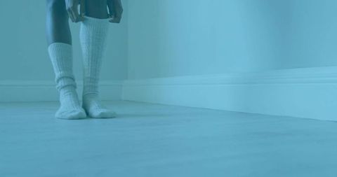 Woman dressing in ribbed knit socks for comfort and relaxation