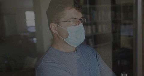 Professional Reflecting Wearing Mask Standing in Peaceful Home Office