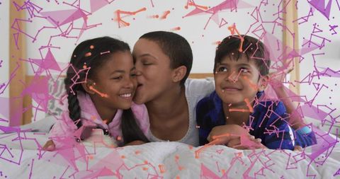 Mother kissing smiling children on bed sharing cozy family moment with playful overlays