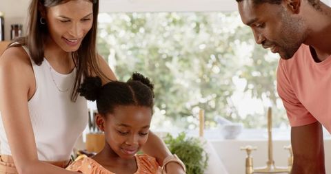 Diverse Family Preparing Meal Together in Bright Kitchen