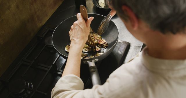 Chef Sautés Mushrooms in Modern Kitchen Pan From Above - Download Free Stock Images Pikwizard.com