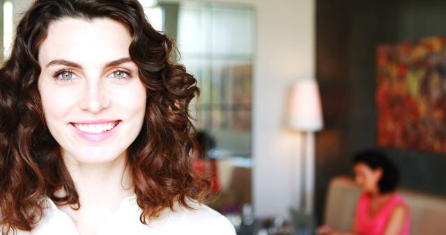 Smiling Woman with Curly Hair in Office Environment - Download Free Stock Images Pikwizard.com