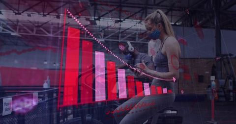 Masked woman cycling on stationary bike with red fitness analytics overlay decline