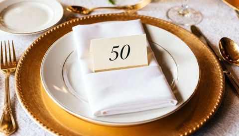 Golden 50 Table Card on White Plate and Gold Charger with Linen Napkin Elegant Table