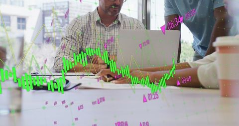 Coworkers Analyzing Business Growth Strategies with Digital Graphs
