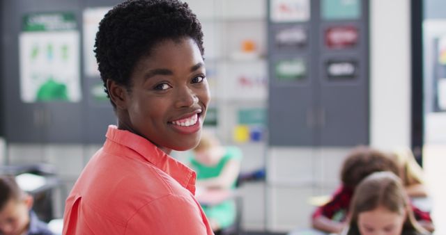 Smiling Female Teacher in Classroom with Students in Background - Download Free Stock Images Pikwizard.com