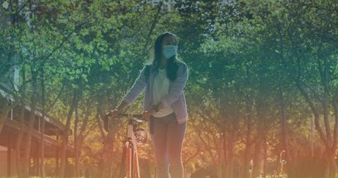 Woman Walking with Bicycle in Sunlit Park During Pandemic - Download Free Stock Images Pikwizard.com