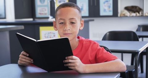 Freckled Biracial Boy Reading in Classroom, Red Shirt, School Learning