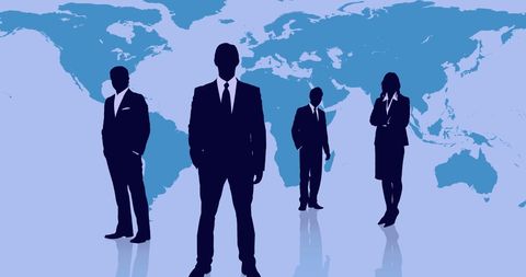 Silhouetted Business Professionals Against World Map