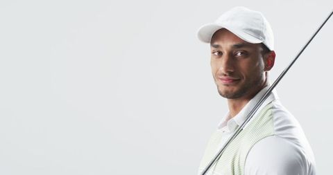 Confident Young Man Holding Golf Club in Stylish Sportswear