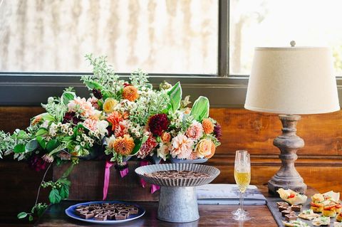 Elegant indoor floral arrangement with snacks and champagne