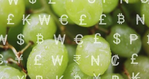 Glistening green grapes closeup with currency symbols overlay for finance concept