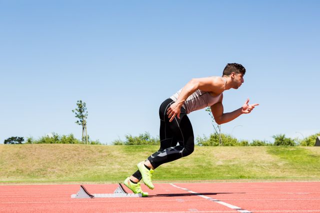 Athlete sprinting on a running track on a sunny day, showcasing fitness and determination. Ideal for use in sports and fitness advertisements, motivational posters, athletic training programs, and health and wellness campaigns.