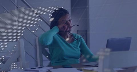 Exhausted Professional Woman at Workspace Adjusts Glasses
