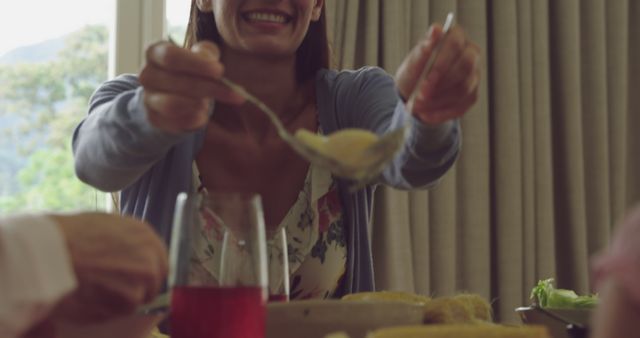 Smiling Woman Serving Family Meal at Home Gathering - Download Free Stock Images Pikwizard.com