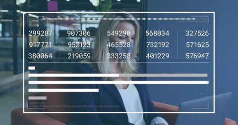 Businesswoman Analyzing Data on Laptop in Modern Office Lounge