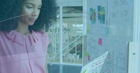Businesswoman Analyzing Financial Data with Transparent Screens