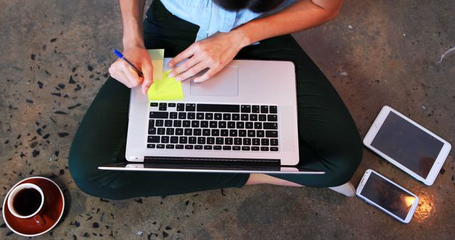 Person Working on Laptop with Coffee and Digital Devices on Floor - Download Free Stock Images Pikwizard.com