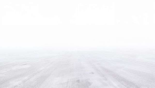 Expansive concrete surface stretching toward pale horizon minimal high-key background