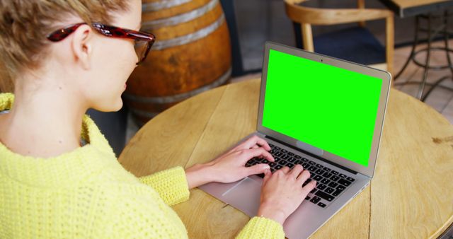 Young Woman Working Remotely on Laptop with Green Screen at Cafe - Download Free Stock Images Pikwizard.com