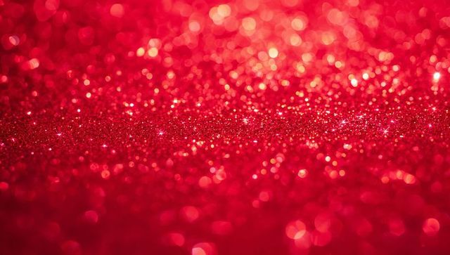 Shimmering crimson glitter bokeh background sparkling with shallow focus and festive sparkle
